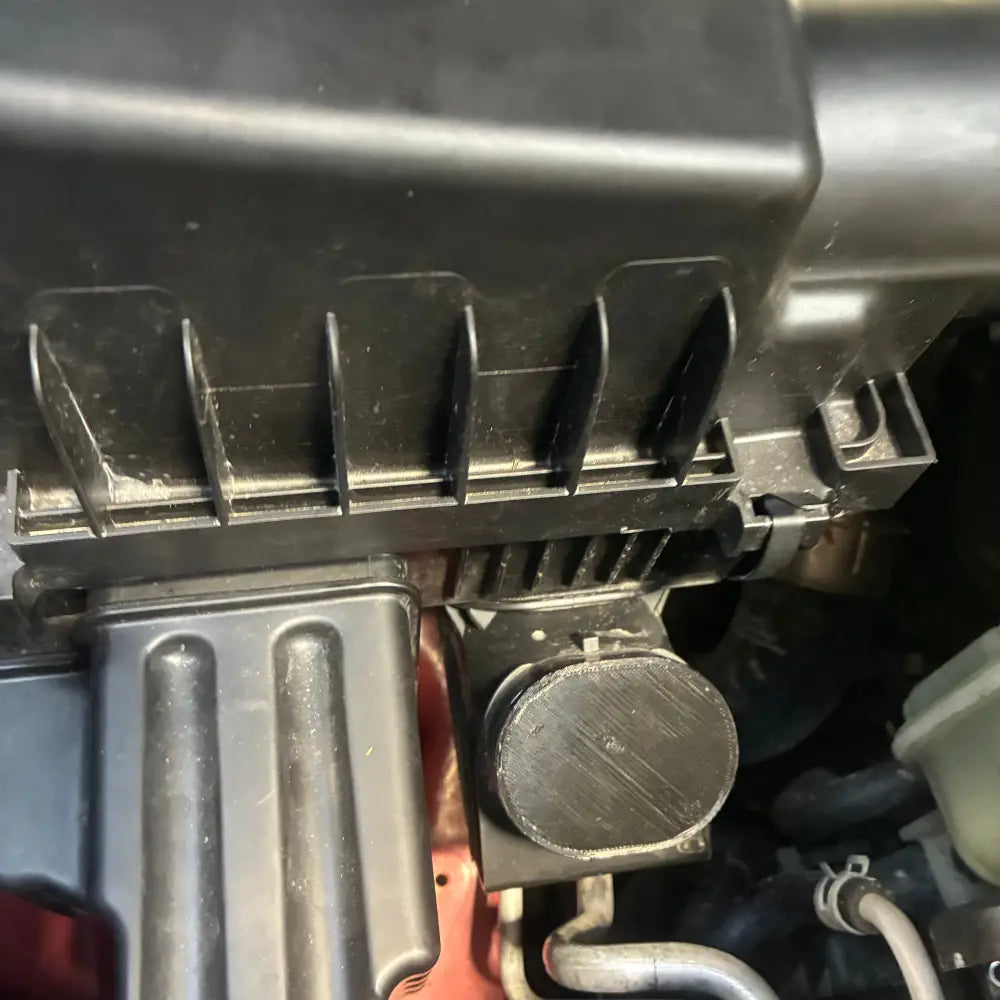 Close-up of a mechanical component with visible branding on a dark background