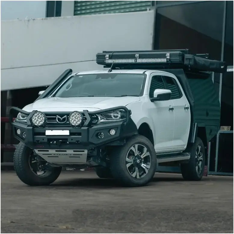 White Mazda pickup truck with off-road modifications featuring Rockarmor GT bull bar and driving lights