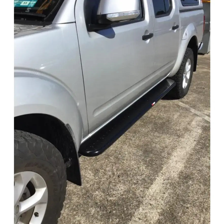 Silver pickup truck with black running board featuring rockarmor rockslider brushbar for nissan navara d40 2005-2015