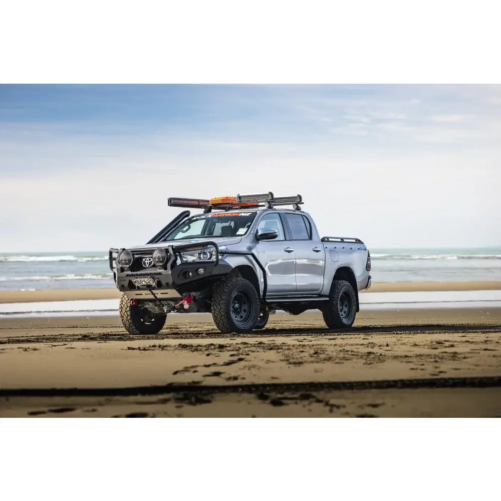 Silver Toyota Hilux N80 with rockarmor gt hoop steel bullbar featuring rated recovery points full bar replacement