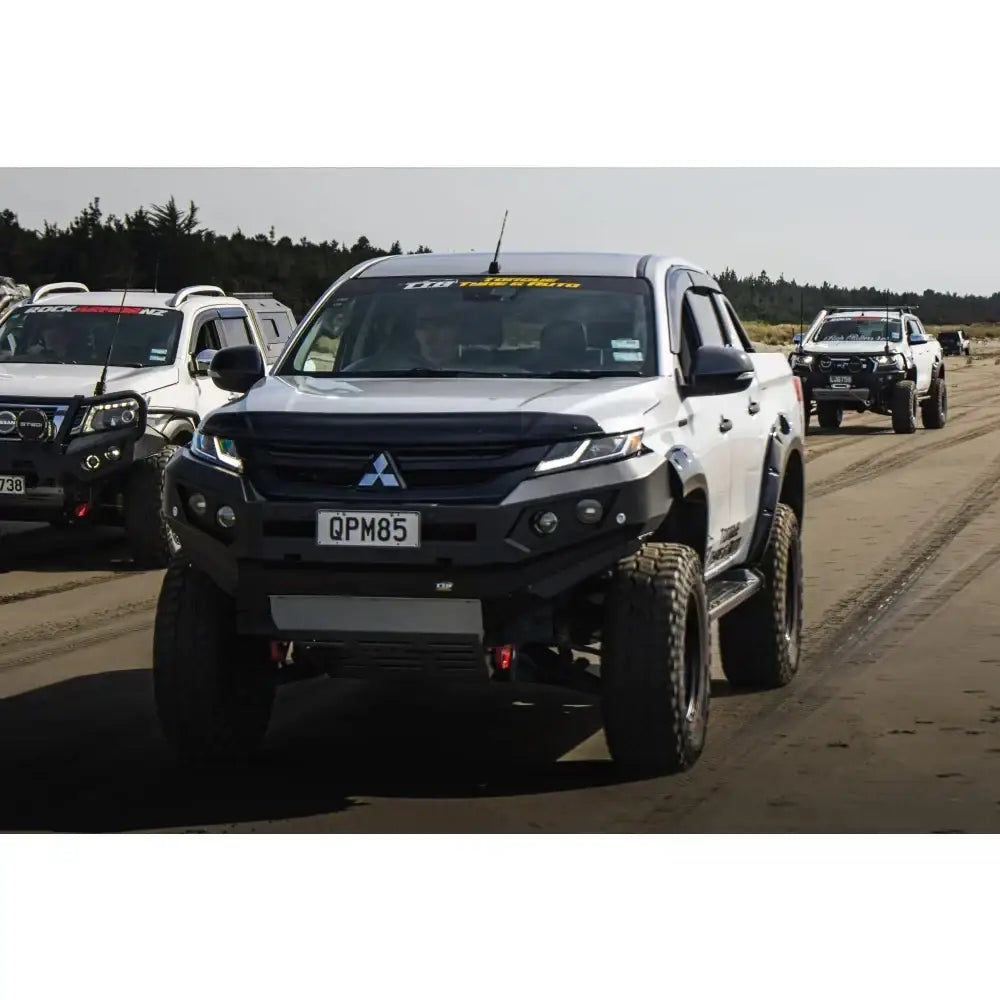 Modified white mitsubishi mr triton pickup truck with rockarmor gt steel hoopless bullbar and synthetic winch rope installed