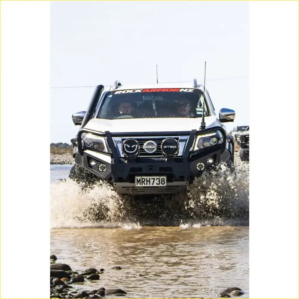 White Nissan st-30 pickup with black GT hoop bullbar front guard and roof rack from Rockarmor Rock Pack for Navara NP300