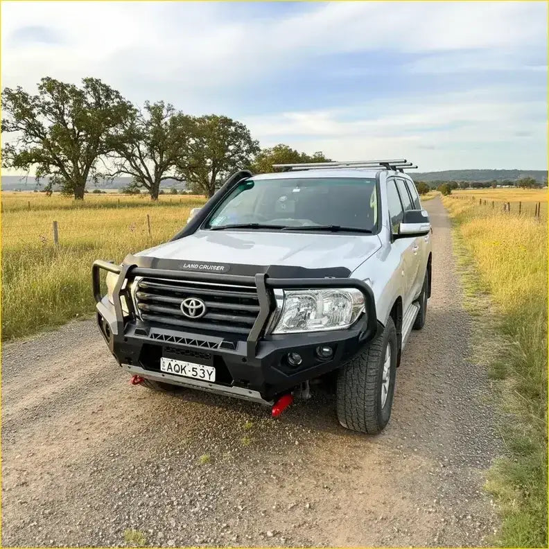 Silver toyota land cruiser with black gt hoop bullbar front bumper and roof rack from rockarmor rock pack 07-15+