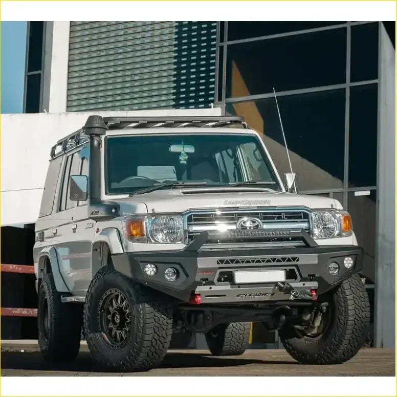 Silver toyota land cruiser 70 with black off-road tires and gt hoopless bullbar from rockarmor rock pack