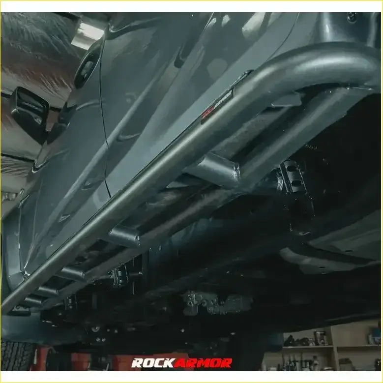 Black metal rockarmor rock pack guard with rugged tubular design and visible welds for toyota hilux n70 12-15