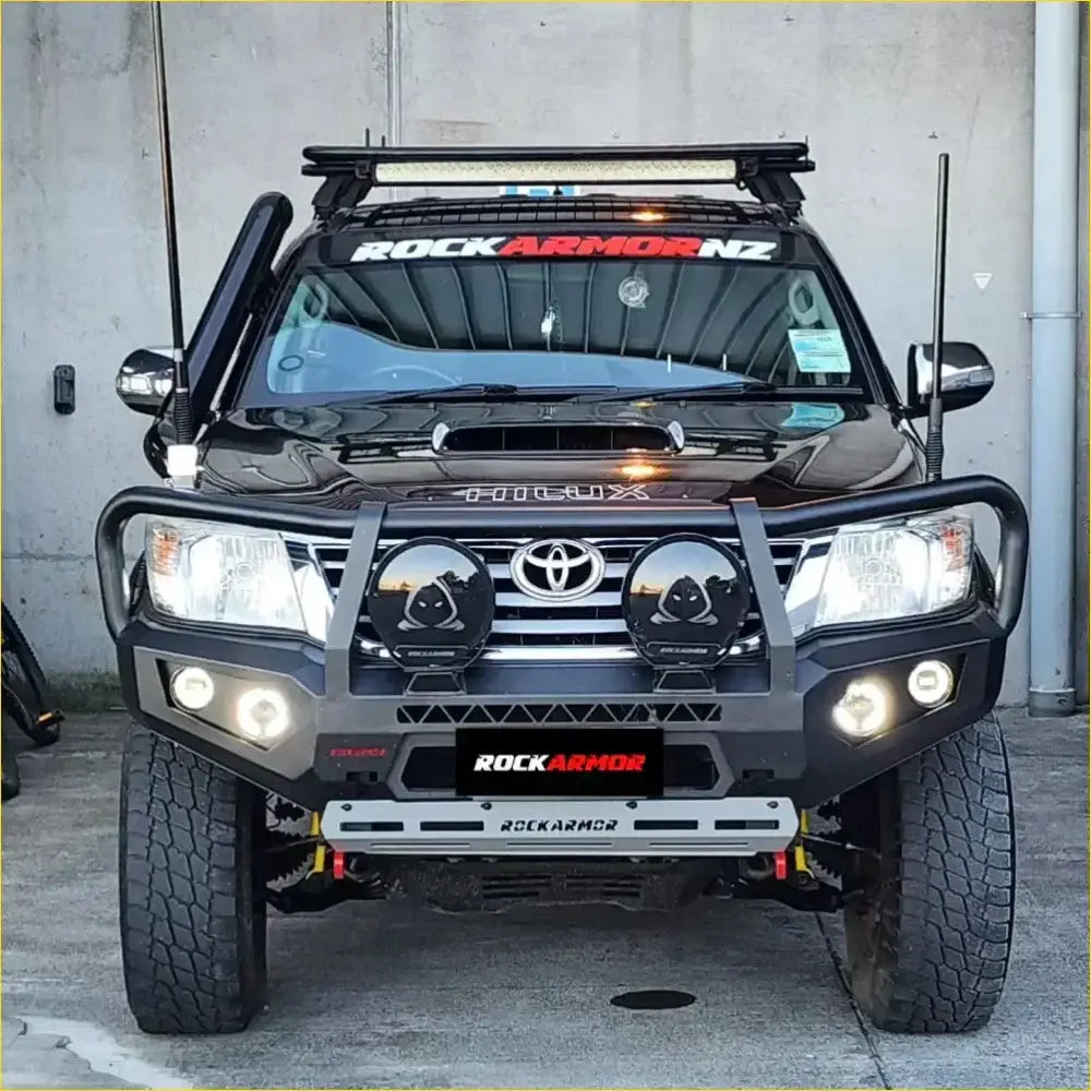 Black toyota land cruiser with rugged rockarmor rock pack featuring gt hoop bullbar and rock sliders for off-road use