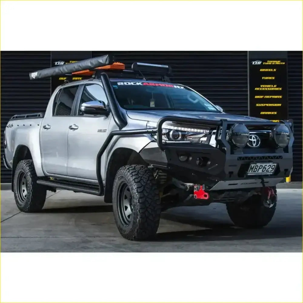 Silver Toyota Hilux pickup with black Rockarmor Rock Pack N80 bullbar and rock sliders for off-road use