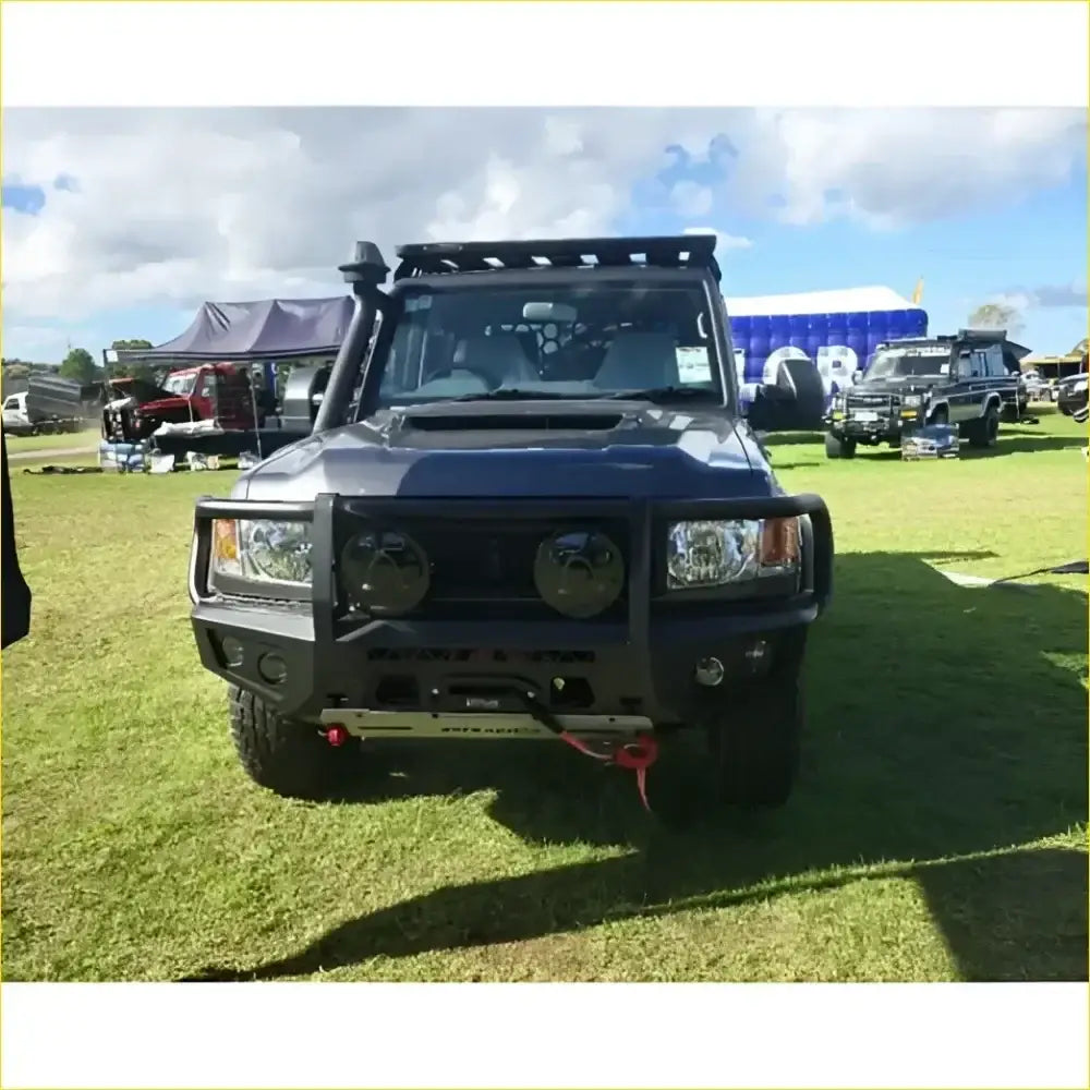 Black armored off-road toyota landcruiser 78 troopy with rugged gt hoop bullbar rock sliders and roof rack