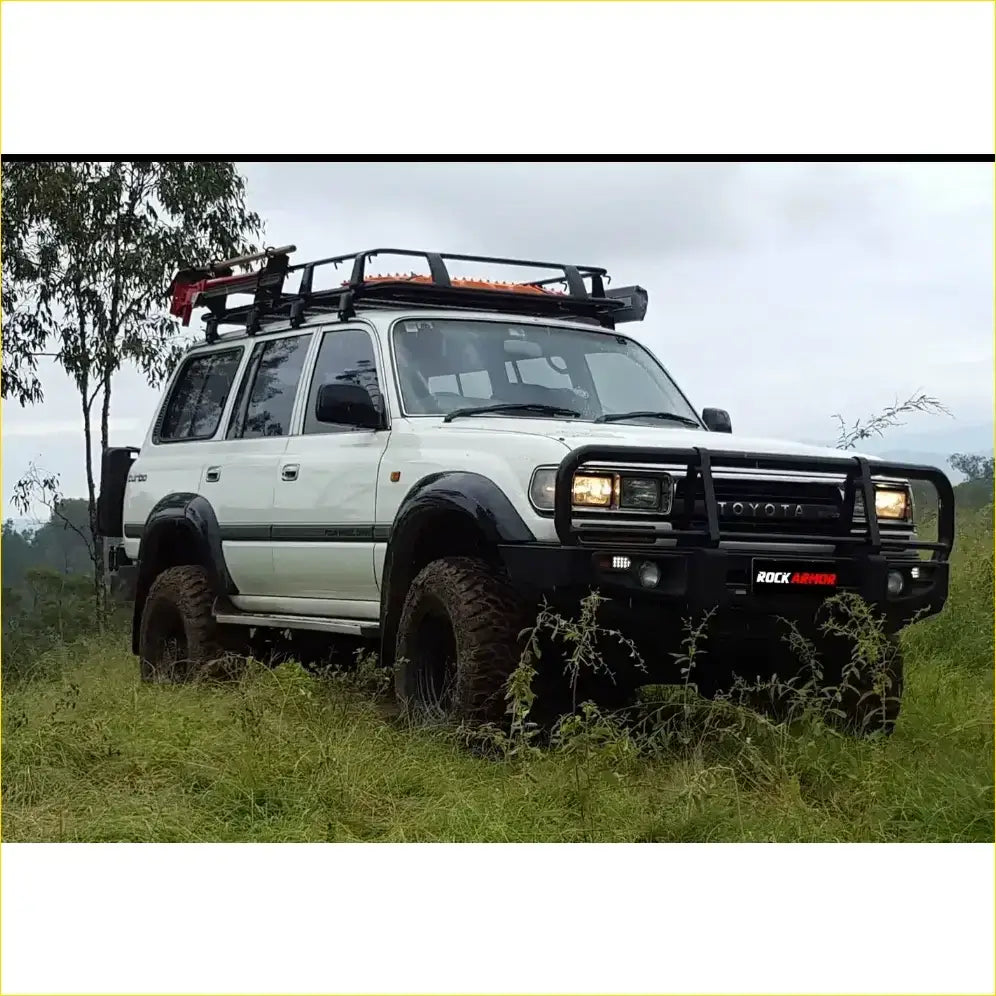 White toyota land cruiser fj80 with black metal bullbar and roof rack from rockarmor rock pack premium set