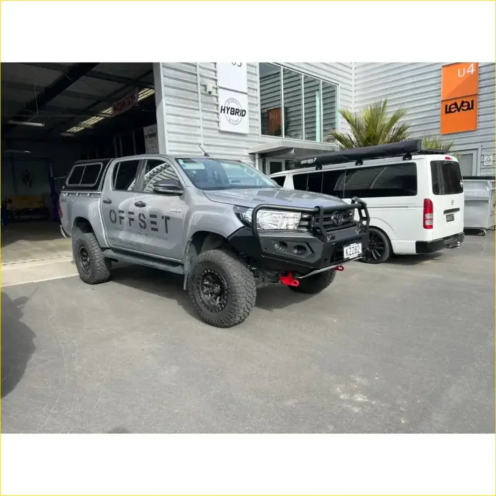 Silver toyota hilux 2020 with black off-road rockarmor rock pack featuring gt hoop bullbar and rock sliders side view
