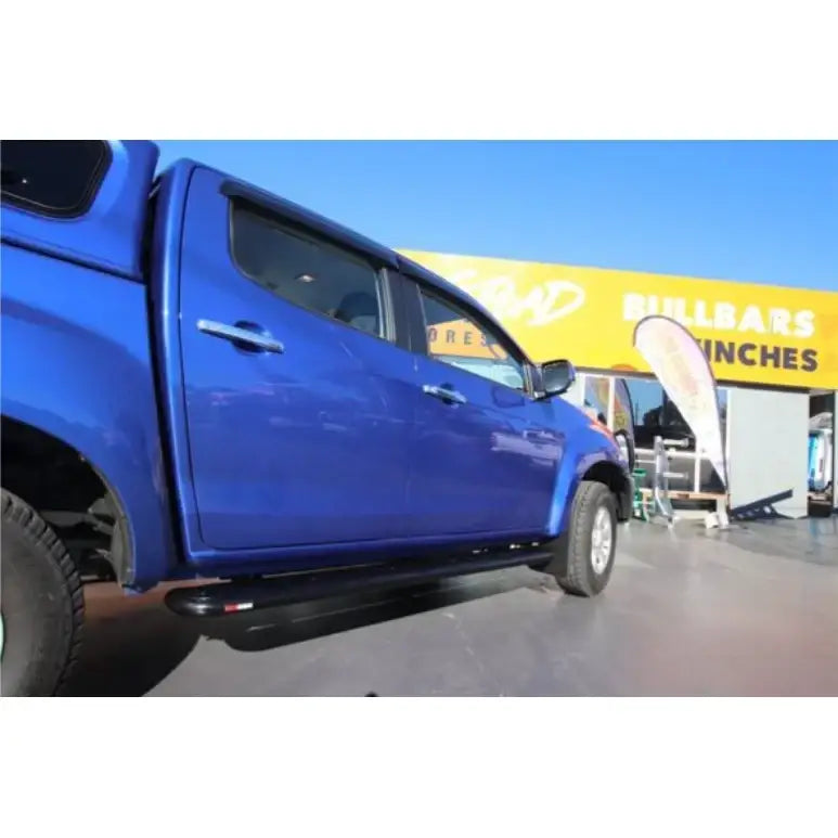 Blue isuzu dmax dual cab with rockarmor steel rockslider side steps compatible with brush bar shown from back side