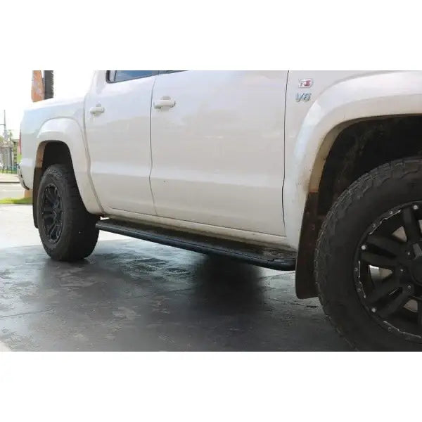 White pickup truck with rockarmor steel rockslider side steps in black suit vw amorok and brush bar compatible