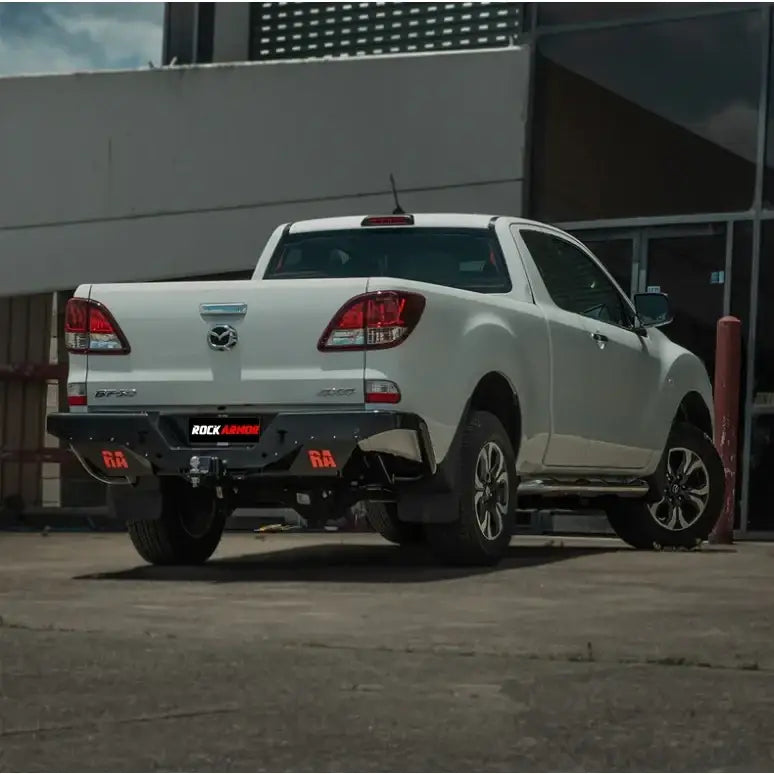 White Mazda BT-50 pickup truck showing the back side with rockamor elite steel rear step and towbar installation