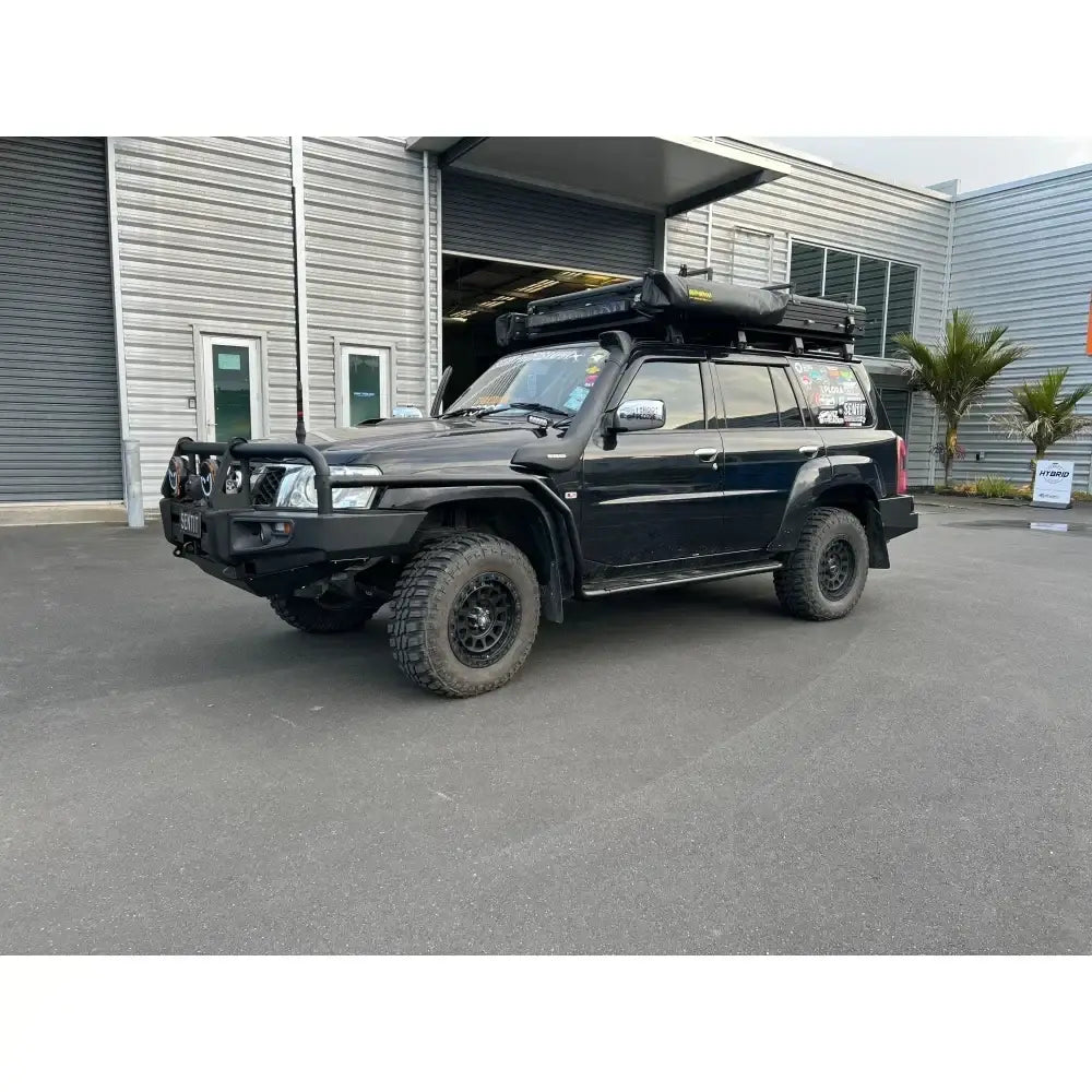 Black rockarmor brushbar on nissan patrol gu4 with roof tent suited for gt bullbar off-road protection