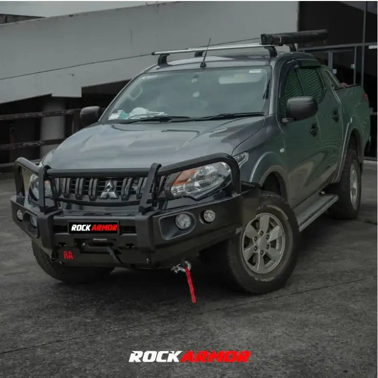 Gray mitsubishi triton with black rockarmor elite bullbar featuring synthetic winch rope for off-road protection