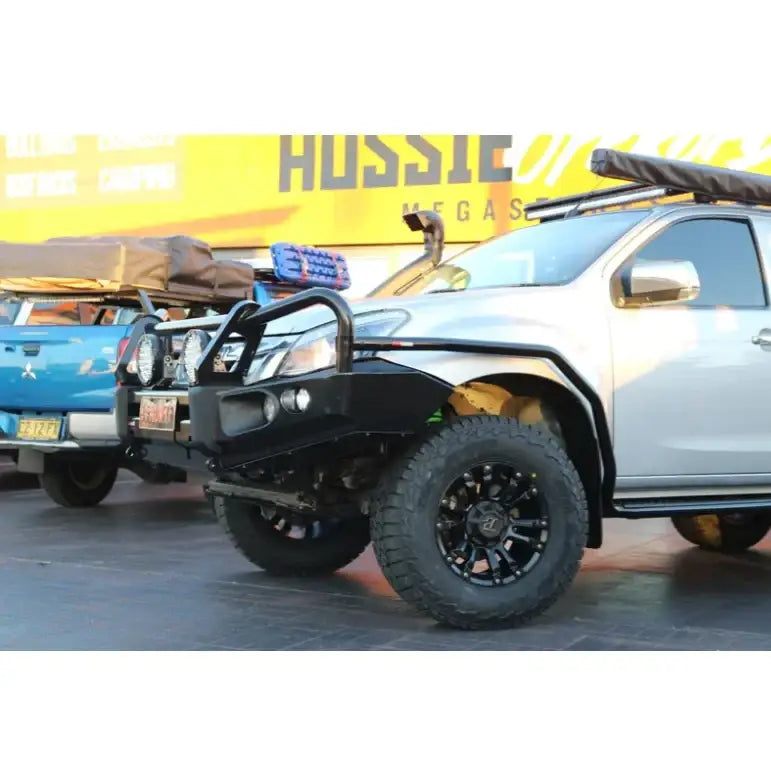 Silver off-road Isuzu Mux 2013-2017 with Rockarmor Elite Hoop bull bar featuring integrated fog lights
