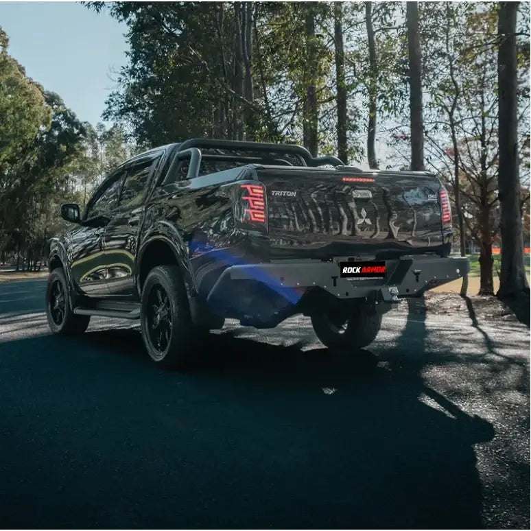Black Mitsubishi Triton mq 2015-2018 fitted with rockarmor elite steel rear step and elite rear tow bar at the back side