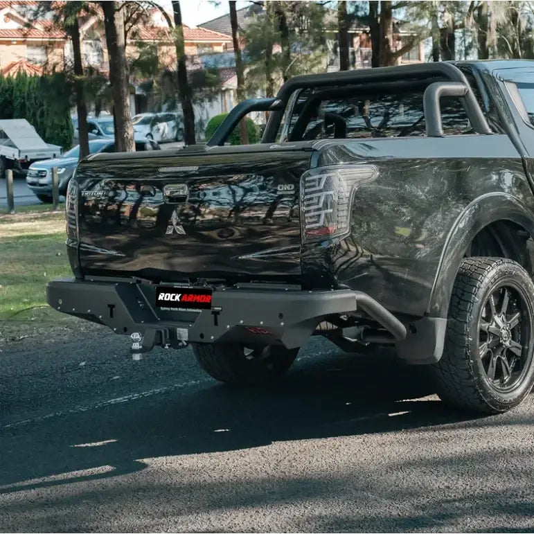 Black pickup truck rear showing rockarmor elite steel rear step tow bar in steel for mitsubishi triton mq 2015 2018