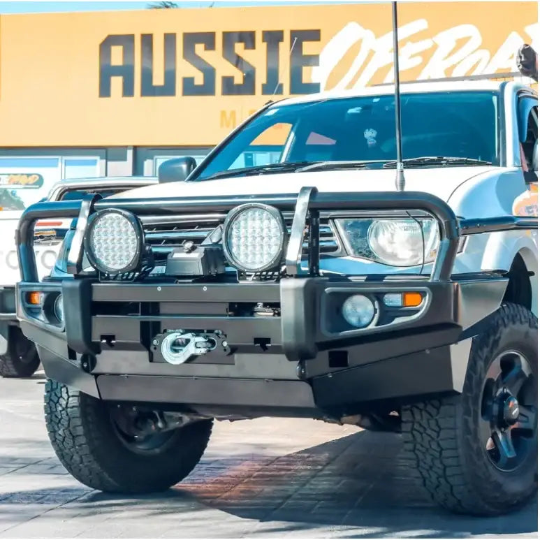 White mitsubishi triton equipped with rockarmor premium steel bullbar featuring black bull bar and led fog lights
