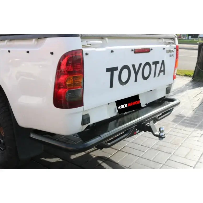 White toyota hilux n70 with rockarmor premium steel rear step and tow bar featuring 2500kg towing capacity