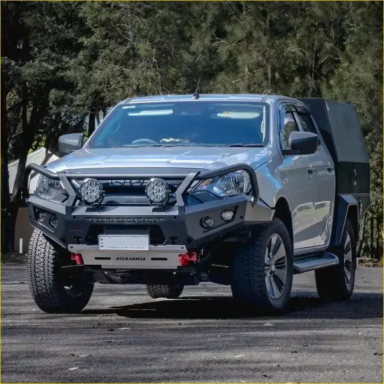 Silver isuzu dmax 2024 pickup with black gt hoop bullbar and rock sliders from rockarmor rock pack on rugged tires