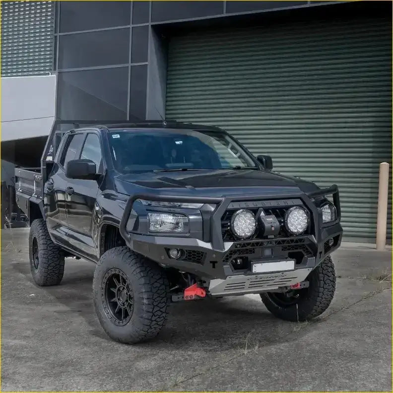Black lifted mitsubishi mv triton 2024 with rockarmor gt hoop bullbar and rock sliders featuring off-road tires and aux lights