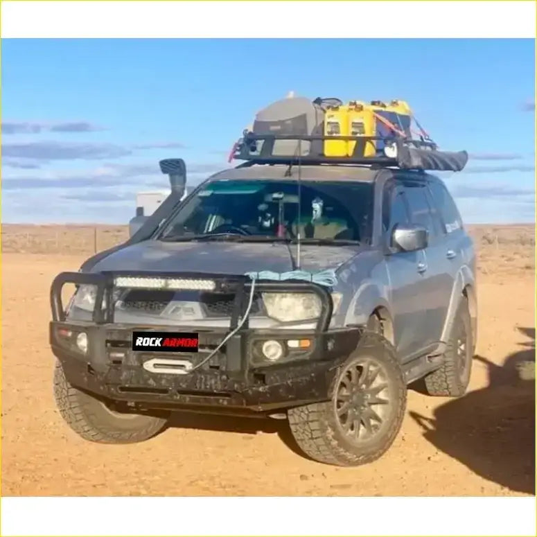 Dark gray mitsubishi triton challenger with black premium bullbar and roof rack carrying yellow gear from rockarmor rock pack