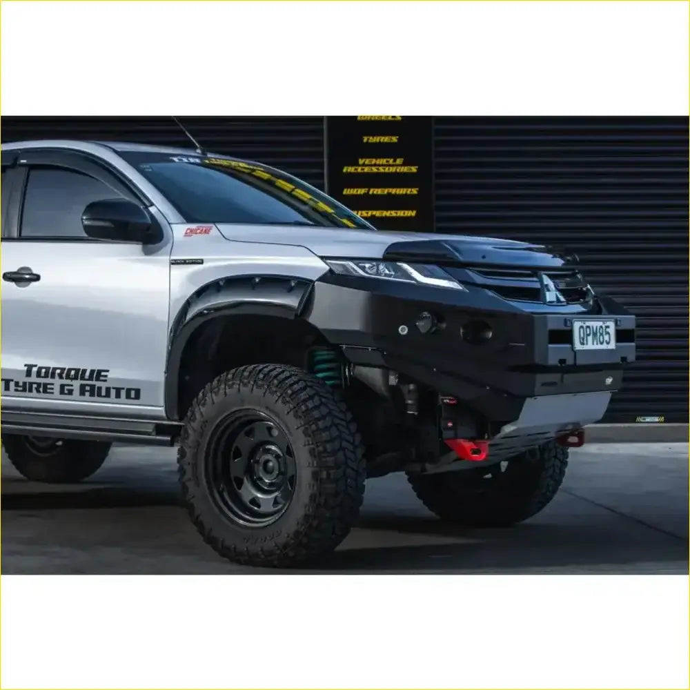 Black rockarmor rock pack aftermarket front bumper with winch mount and red recovery points on silver mitsubishi triton