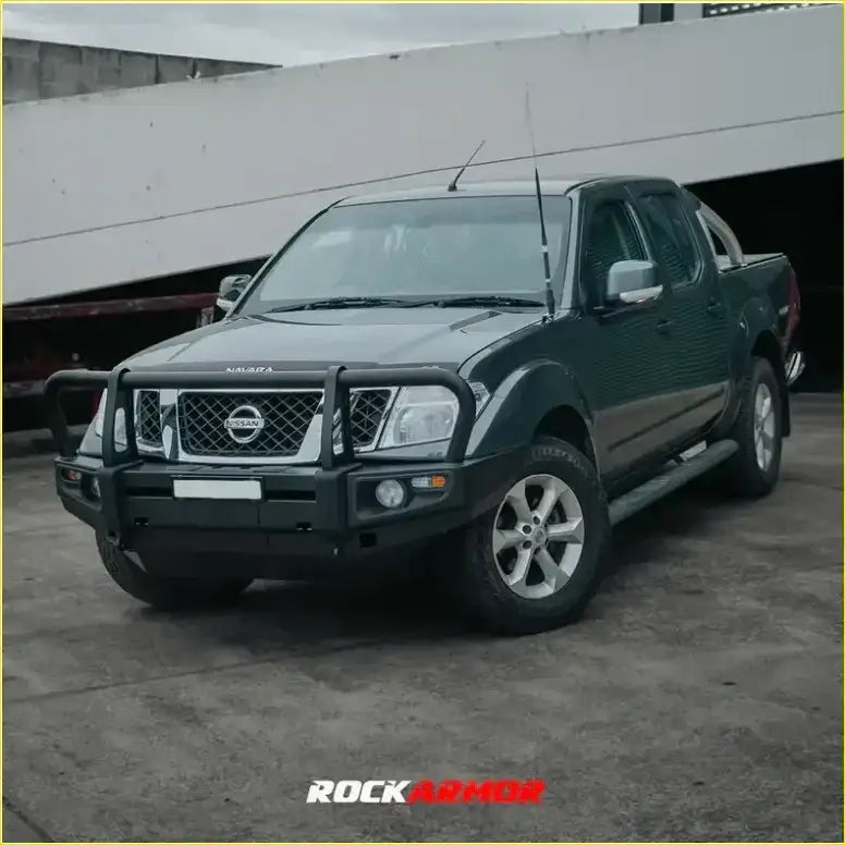 Black nissan frontier pickup truck with rockarmor rock pack premium bullbar and silver alloy wheels for off-road use