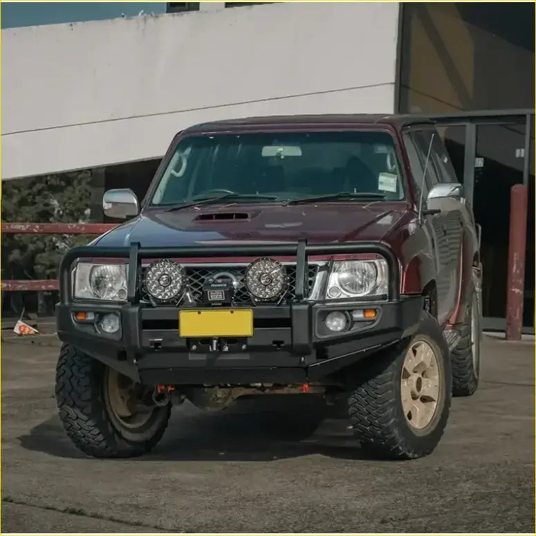 Maroon Nissan Patrol with black rockarmor premium bullbar and rugged off-road tires for GU4 2005 to current models