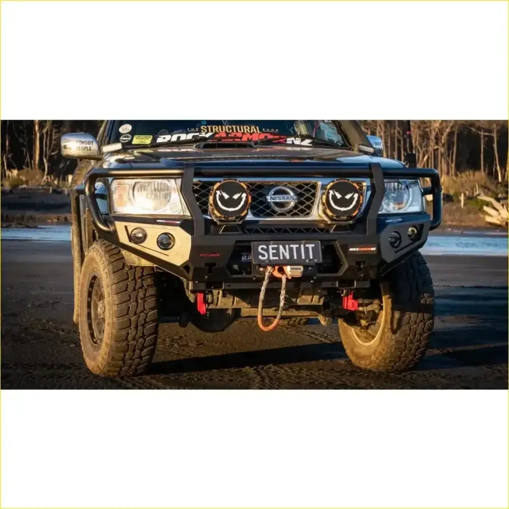 Black rugged rockarmor rock pack front bumper with smiling circular headlights and nissan emblem for patrol gu4+