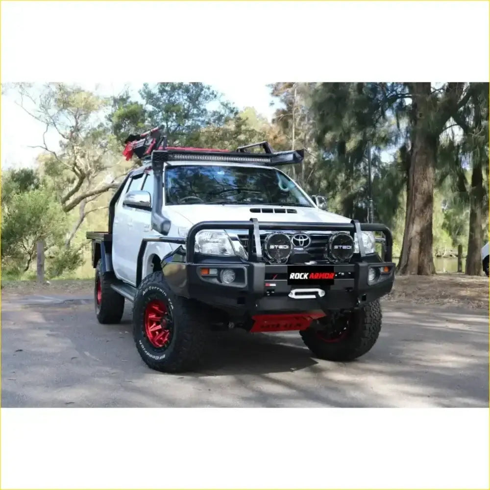 White Toyota Hilux with black red Rockarmor front bumper roof rack and red alloy wheels rock pack bar replacement