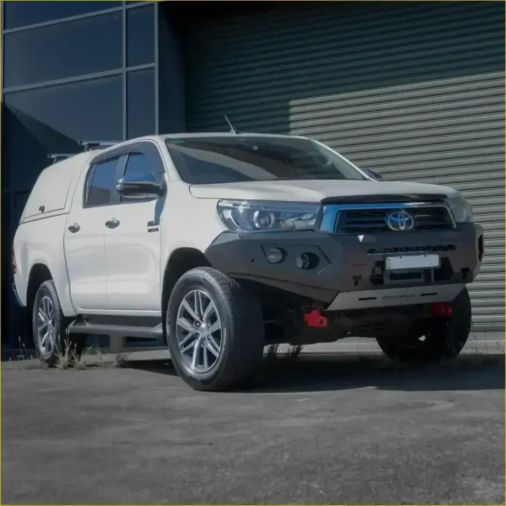 White toyota hilux with black rockarmor gt hoopless bullbar and silver alloy wheels front bumper guard visible