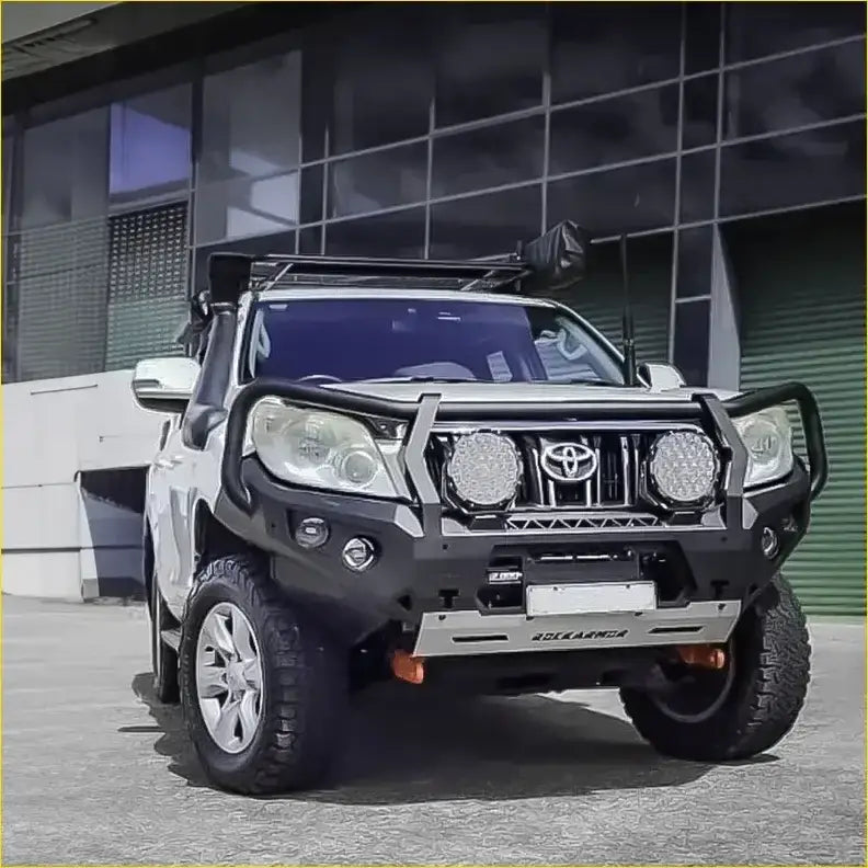 Silver toyota prado 150 series 2009-2013 with black rockarmor gt hoop bullbar roof rack and rock sliders from back