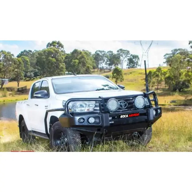 White toyota hilux n80 with black bull bar featuring rockarmor steel rockslider checker plate side steps fitting view