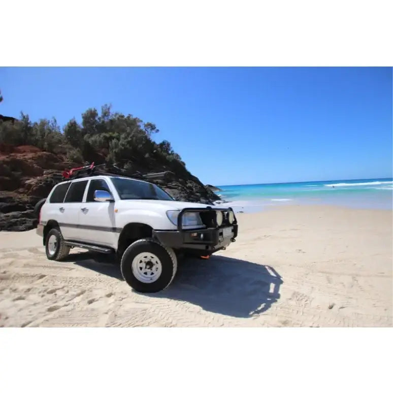 White off-road vehicle showing rockarmor steel rockslider side steps to suit toyota landcruiser wagon solid live axle