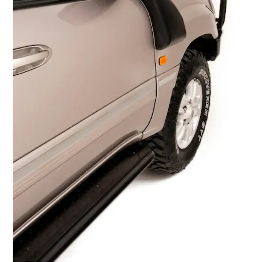 Silver toyota landcruiser fj100 side view featuring rockarmor steel rockslider checker plate step for 1998-2007 models