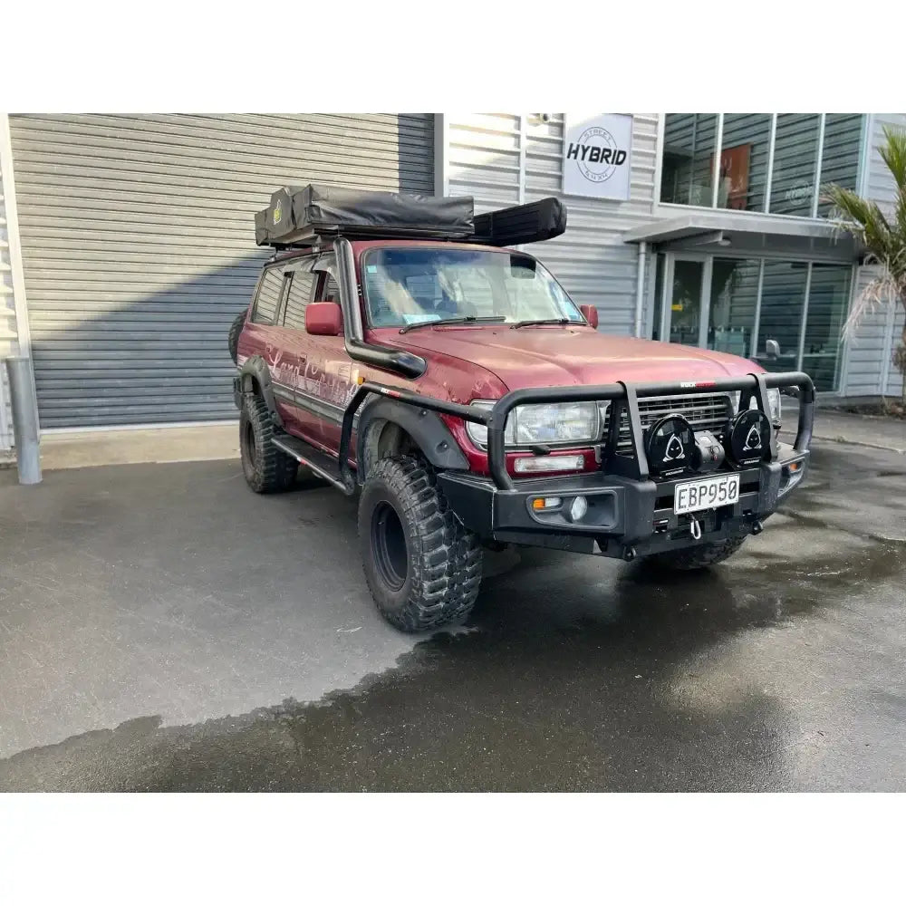 Maroon toyota landcruiser fj80 with rockarmor steel rockslider checker plate step showing the back side of product